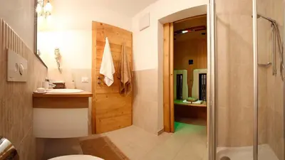 a bathroom with a shower and a toilet and a sink at Apartments Victoria in Ortisei