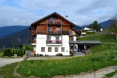 a house on a hill with a balcony at Hintnerhof in Chiusa