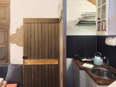 a kitchen with a sink and a counter top at Apartment Mansarda Carezza in Carezza al Lago