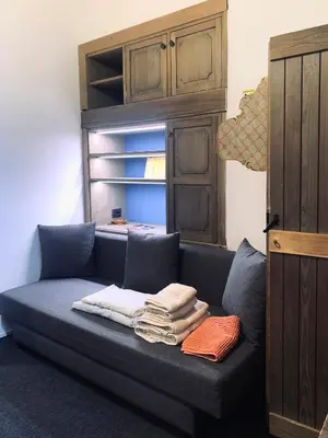a kitchen with a refrigerator and an open door at Apartment Mansarda Carezza in Carezza al Lago