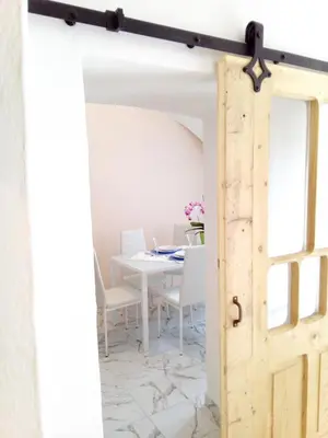 an open door into a dining room with a table at Da Valentina in Castelfondo