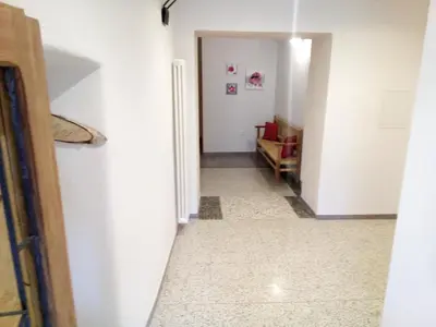 a hallway with white walls and a white floor at Da Valentina in Castelfondo