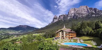 a resort with a mountain in the background at Parc Hotel Miramonti in Fiè