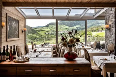 a dining room with tables and a large window at Parc Hotel Miramonti in Fiè