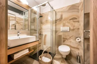 a bathroom with a sink and a toilet and a shower at Parc Hotel Miramonti in Fiè