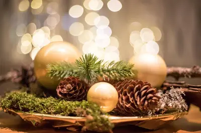 a plate of christmas decorations on a table with lights at Hotel Elefant in Ora/Auer