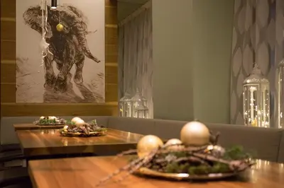 a dining room with two tables with food on them at Hotel Elefant in Ora/Auer
