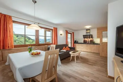 a living room with a table and a couch at Moarlhof - Farm Nature Resort in Castelrotto