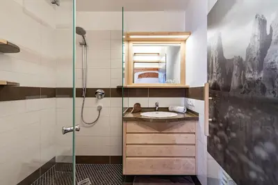 a bathroom with a sink and a shower at Moarlhof - Farm Nature Resort in Castelrotto
