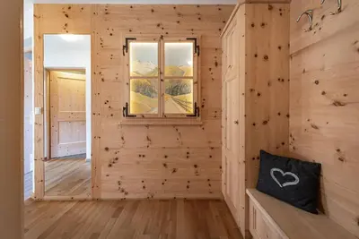 a room with a wooden wall with a window at Moarlhof - Farm Nature Resort in Castelrotto
