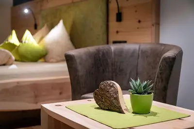 a pineapple sitting on a table next to a chair at Moarlhof - Farm Nature Resort in Castelrotto