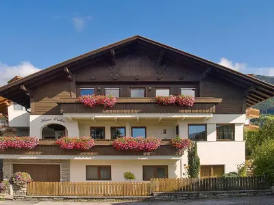 a house with flower boxes on the front of it at Appartements Erika in Falzes