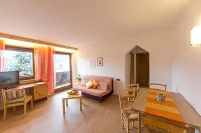 a living room with a table and a couch at Appartements Erika in Falzes