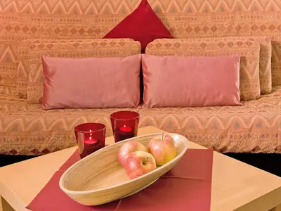 a bowl of apples on a table with two glasses at Appartements Erika in Falzes