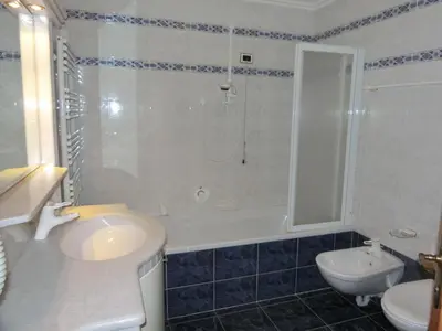 a bathroom with a sink and a shower and a toilet at Garni Criss in Colfosco