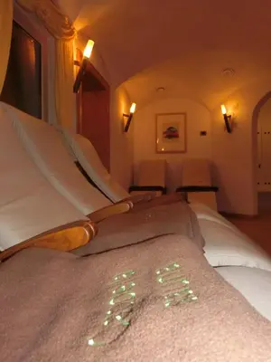 a bed in a room with lights on it at Garni Criss in Colfosco