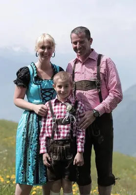 a man and a woman and a child posing for a picture at Thalerhof in Prenn