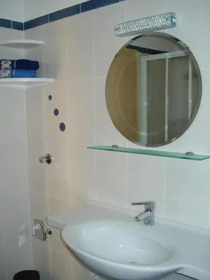a bathroom with a sink and a mirror at Thalerhof in Prenn