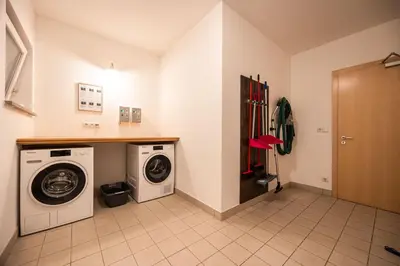 a laundry room with a washer and dryer at EGGER Apartments & Suites in Villandro