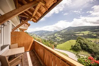 a balcony with a view of the mountains at EGGER Apartments & Suites in Villandro