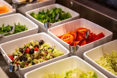 a row of white containers filled with vegetables at Hotel Schmiedhof in Maranza
