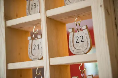 a shelf with wooden doors with numbers on them at Hotel Schmiedhof in Maranza