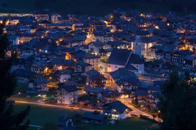 a city lit up at night with houses at Casa Vanna in Mezzano