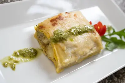a plate of vegetables with a cup of green sauce at TH Borca di Cadore - Park Hotel Des Dolomites in Borca di Cadore