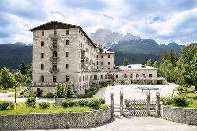 a bathroom with two sinks and a toilet and a shower at TH Borca di Cadore - Park Hotel Des Dolomites in Borca di Cadore