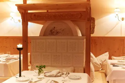 a dining room with two tables with white tablecloths at Hotel Alle Ciaspole in Fondo