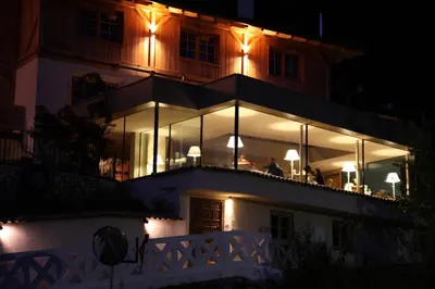 a building with lights on top of it at night at Hotel Alle Ciaspole in Fondo
