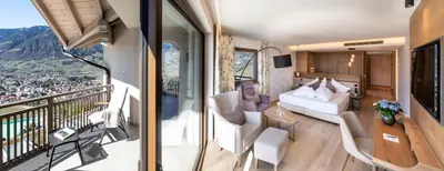 a living room with a view of a mountain at Hotel Sonnbichl in Tirolo