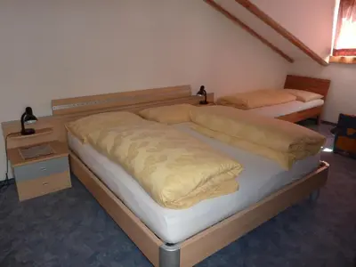 two twin beds in a room with at Gasthof Ebner Pfiffikus in Aldino