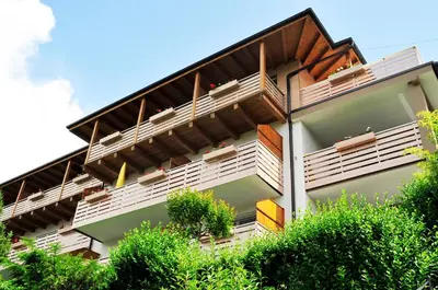 a building with balconies on the side of it at Apparthotel Zunneler in Schenna