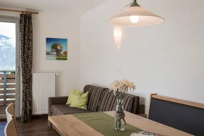 a living room with a couch and a table at Apparthotel Zunneler in Schenna