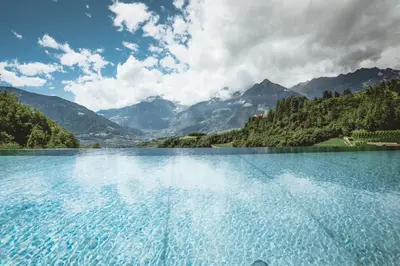 a large body of water with mountains in the background at Prinz Rudolf Smart Hotel in Merano