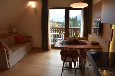 a kitchen and dining room with a table and chairs at Residence Langes in San Martino di Castrozza