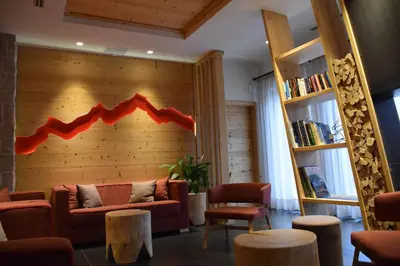 a kitchen and dining room with a table and chairs at Residence Langes in San Martino di Castrozza