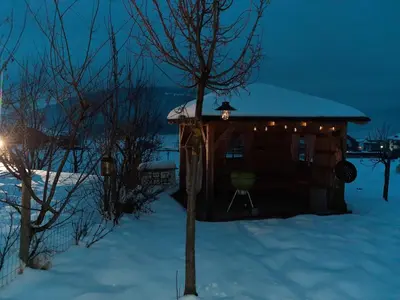 a small cabin in the snow at night at Lerchnhof in Valdaora