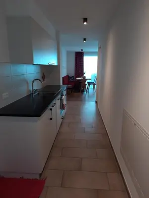 a kitchen with a sink and a tile floor at Lerchnhof in Valdaora