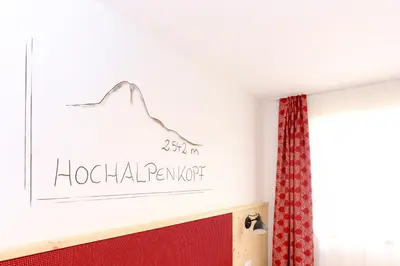 a sign on a wall in a room with a window at Lerchnhof in Valdaora