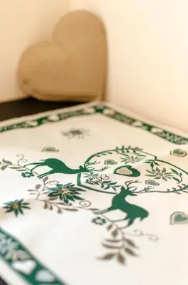 a table with a chair with a pattern on it at Hotel Oswald in Canazei