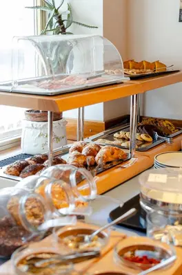 a buffet with various pastries and other food items at Hotel Oswald in Canazei