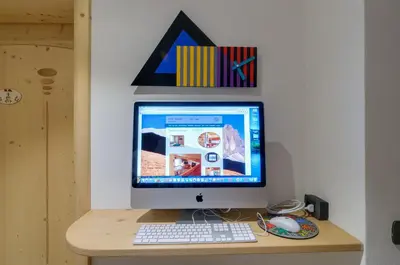 a computer monitor sitting on top of a desk at Apartments Trettel in Tesero
