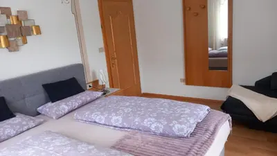 a room with two beds and a mirror at Residence Wiesenheim in Trodena
