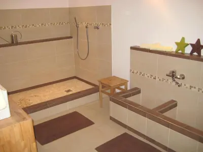 a bathroom with a shower with a tub and a sink at Residence Wiesenheim in Trodena