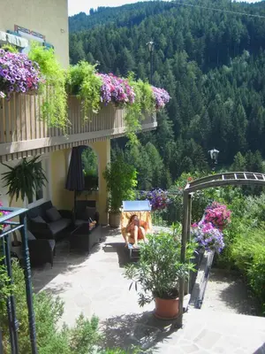 a patio with flowers and plants on a building at Residence Wiesenheim in Trodena