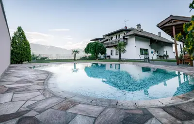 a swimming pool in front of a house at Strahlerhof in Appiano sulla Strada del Vino
