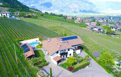 an aerial view of a house in a vineyard at Strahlerhof in Appiano sulla Strada del Vino