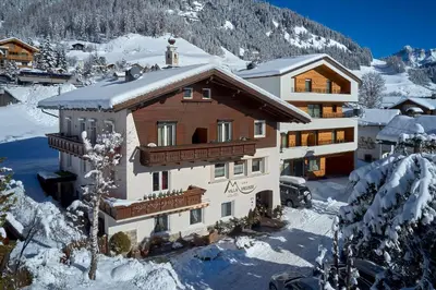 a house in the snow with snow covered at Alpin Relais B&B Villa Melisse in Colfosco